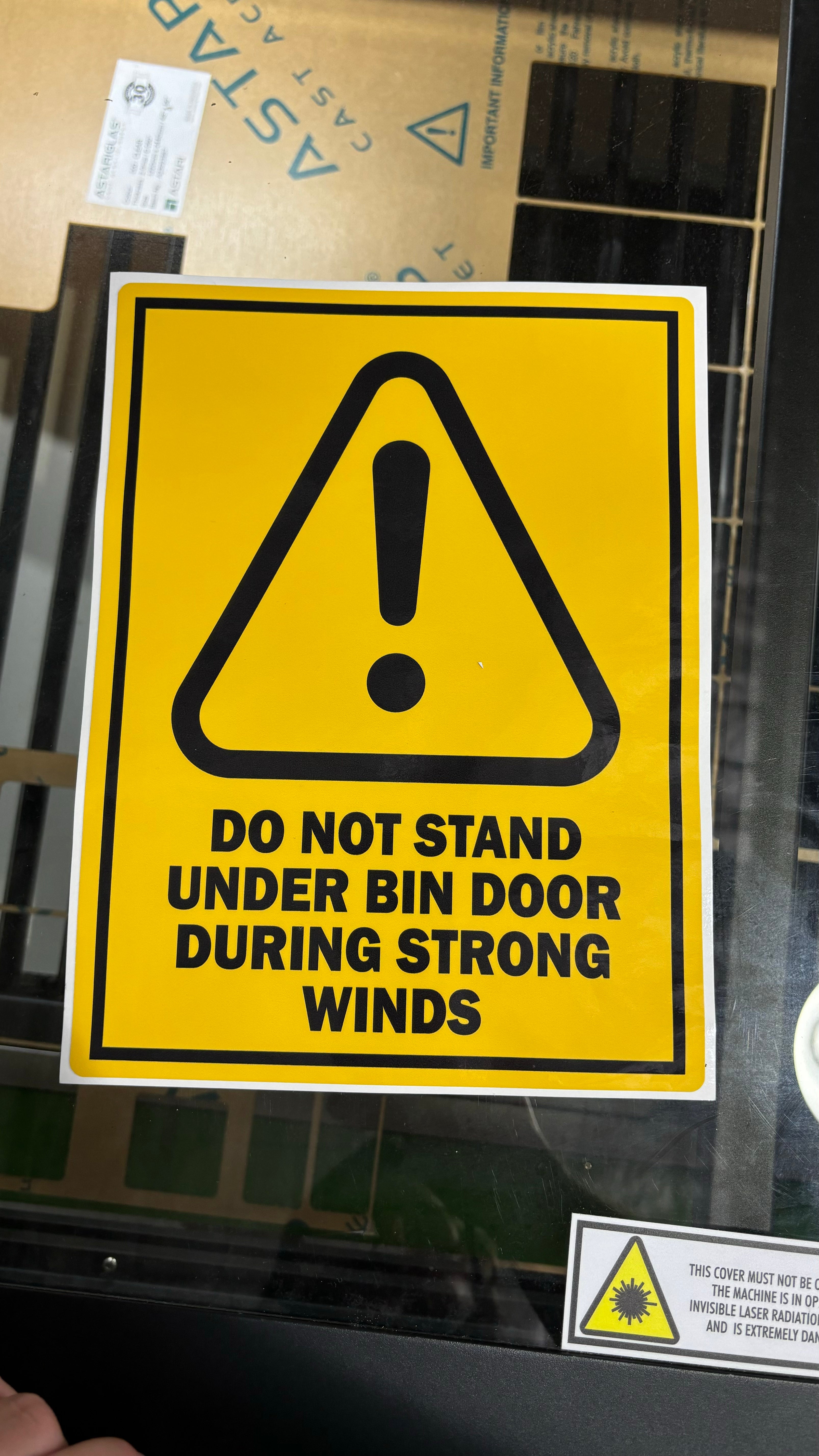 Do not stand under door safety signage