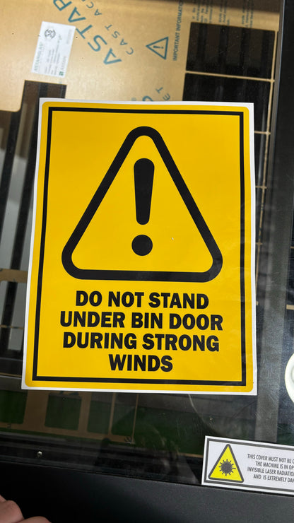Do not stand under door safety signage
